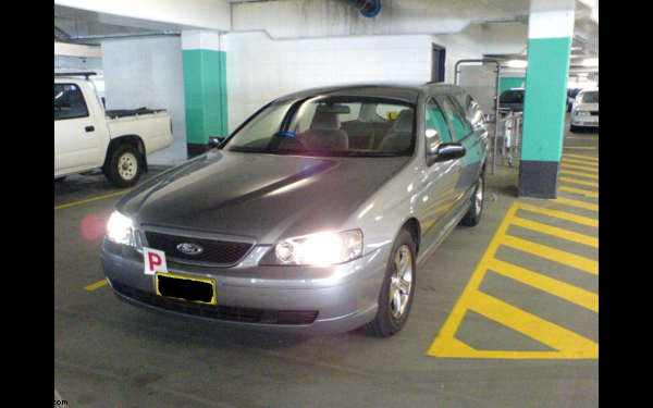 my car with lights on in an undercover carpark